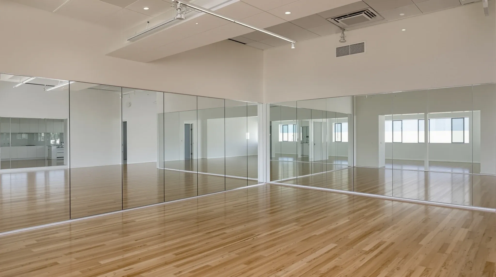 Empty finished studio with timber floor, full mirror wall, high ceiling, no branding