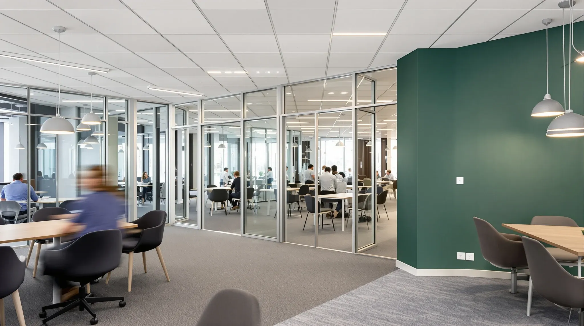 An older office renovated with new paint and flooring while its original glass offices and ceiling stay