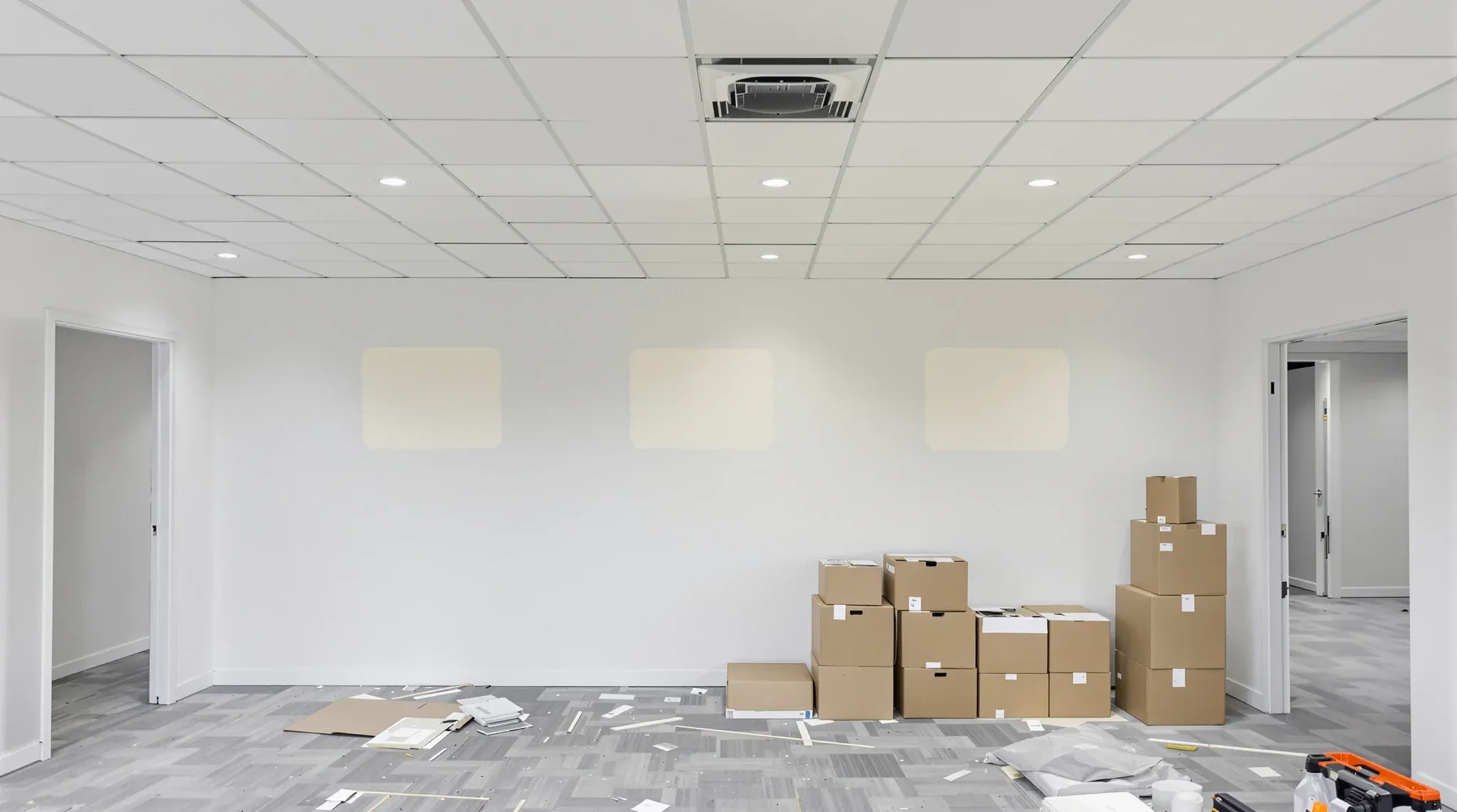 A commercial office mid defit with bare walls and boxes stacked for removal