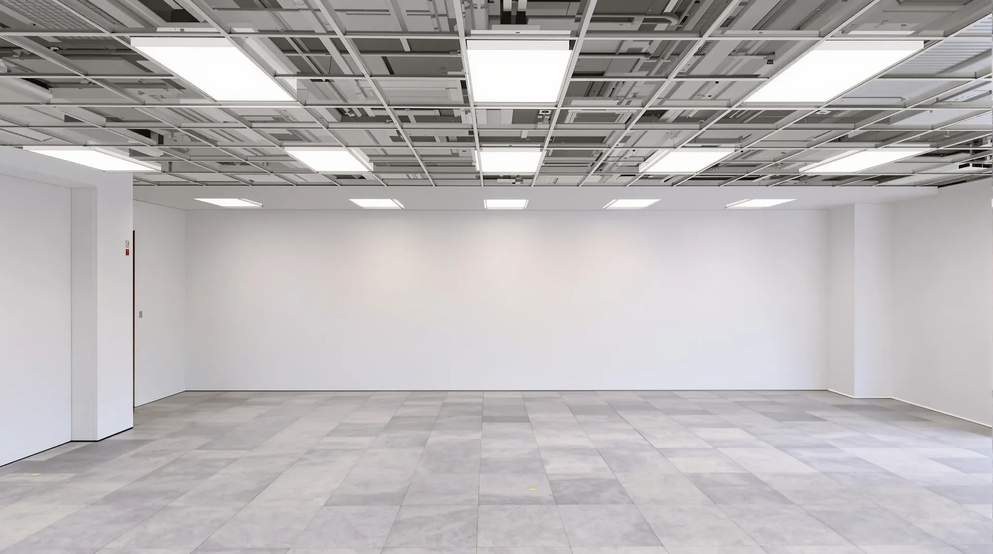 Empty office floor mid-fitout with new partitions framed and ceiling grid partly installed