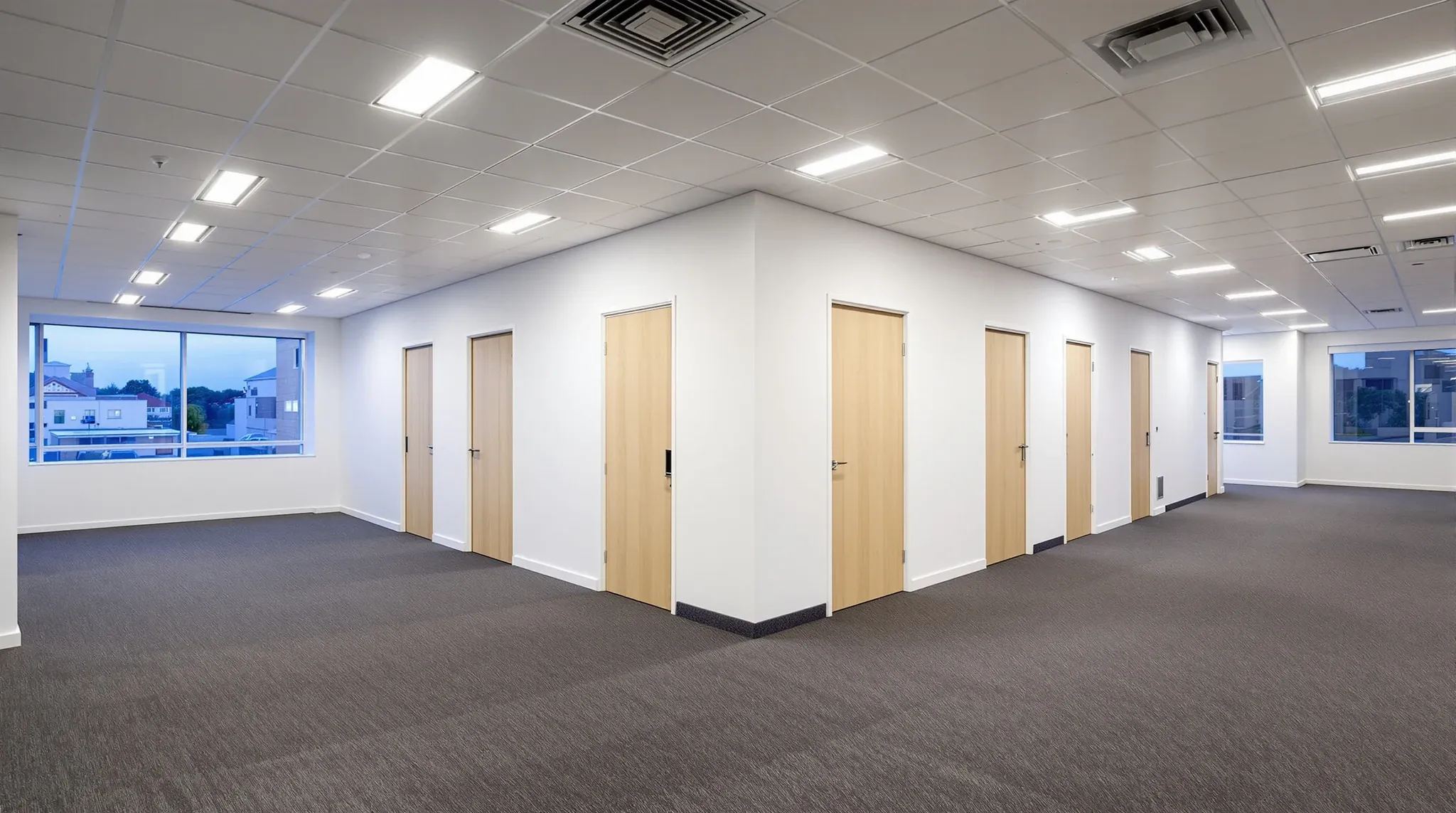 A cluster of new plasterboard meeting rooms in the middle of a fitted-out office floor before move-in