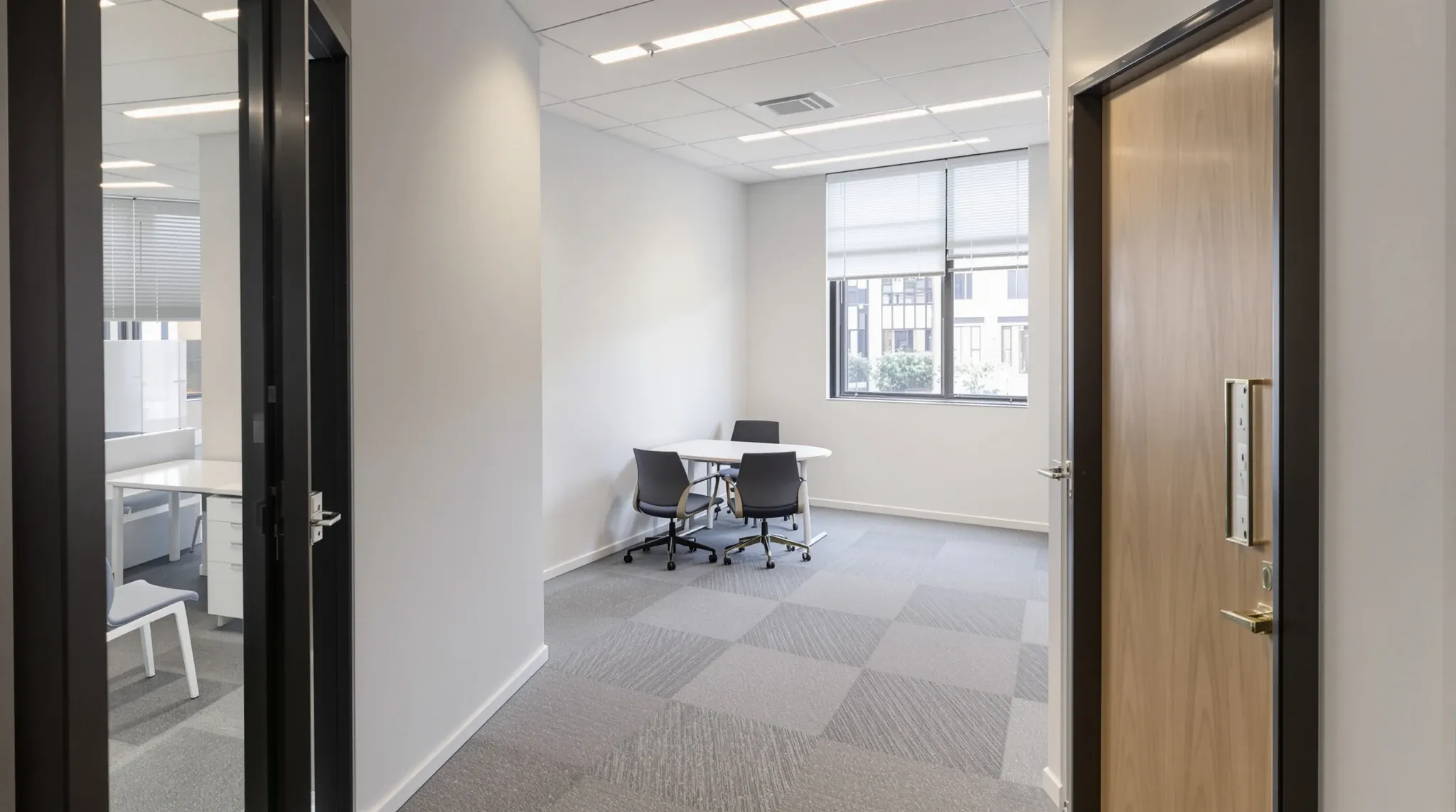 A small, modestly renovated office suite with simple finishes and a compact layout