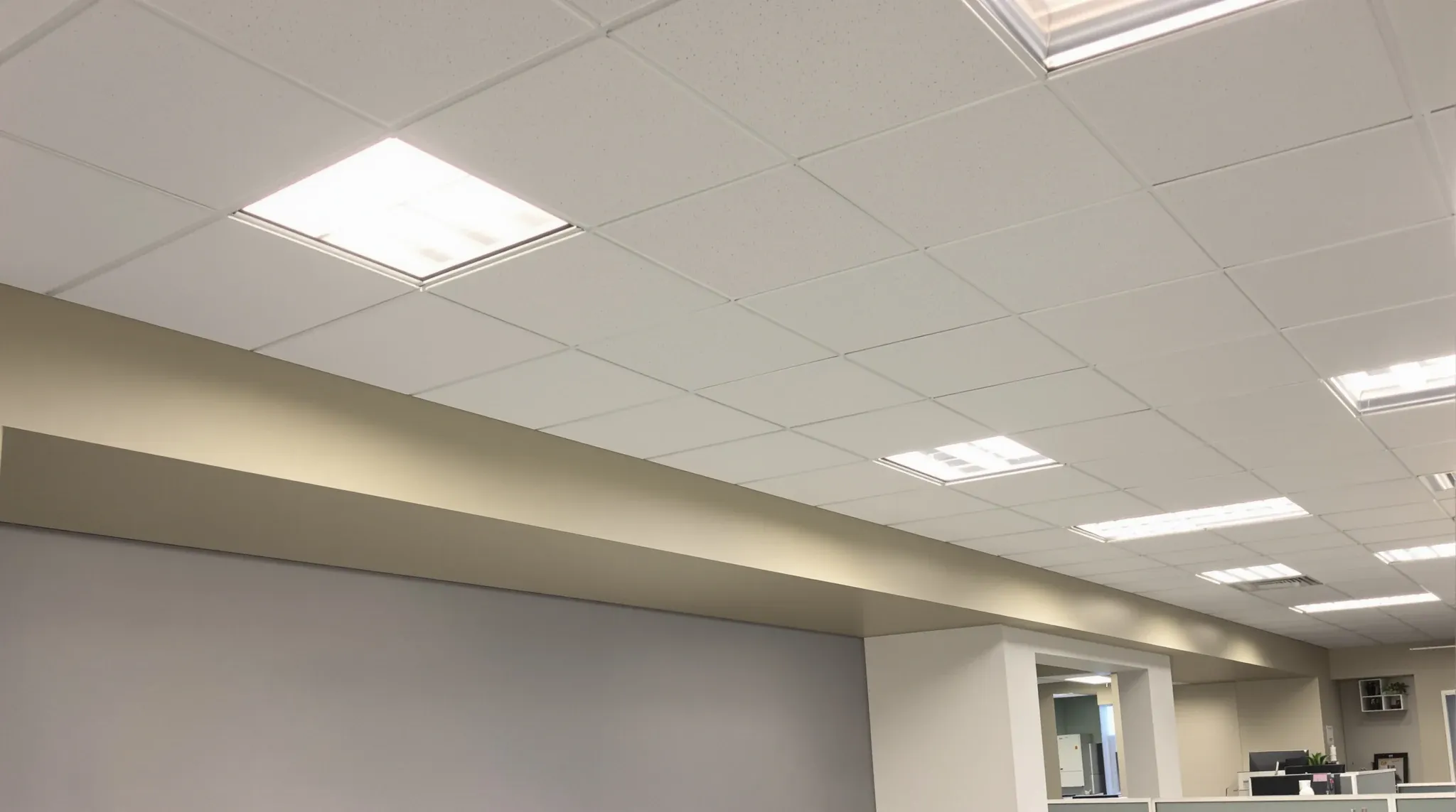 A representative office ceiling in a compact 1980s tower floor with a plain bulkhead