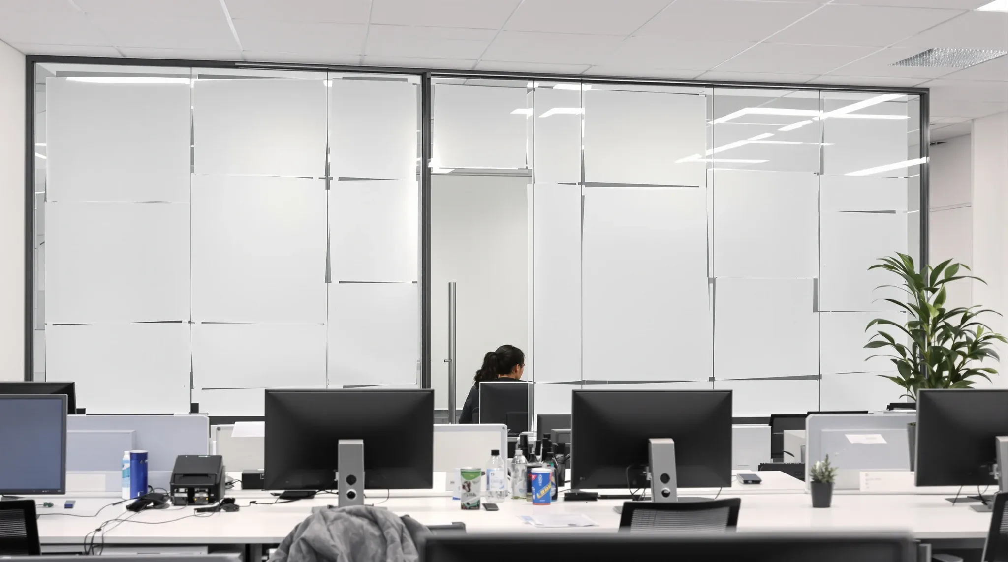 Plain paper taped over the inside of a glass-walled private office for privacy in a busy office