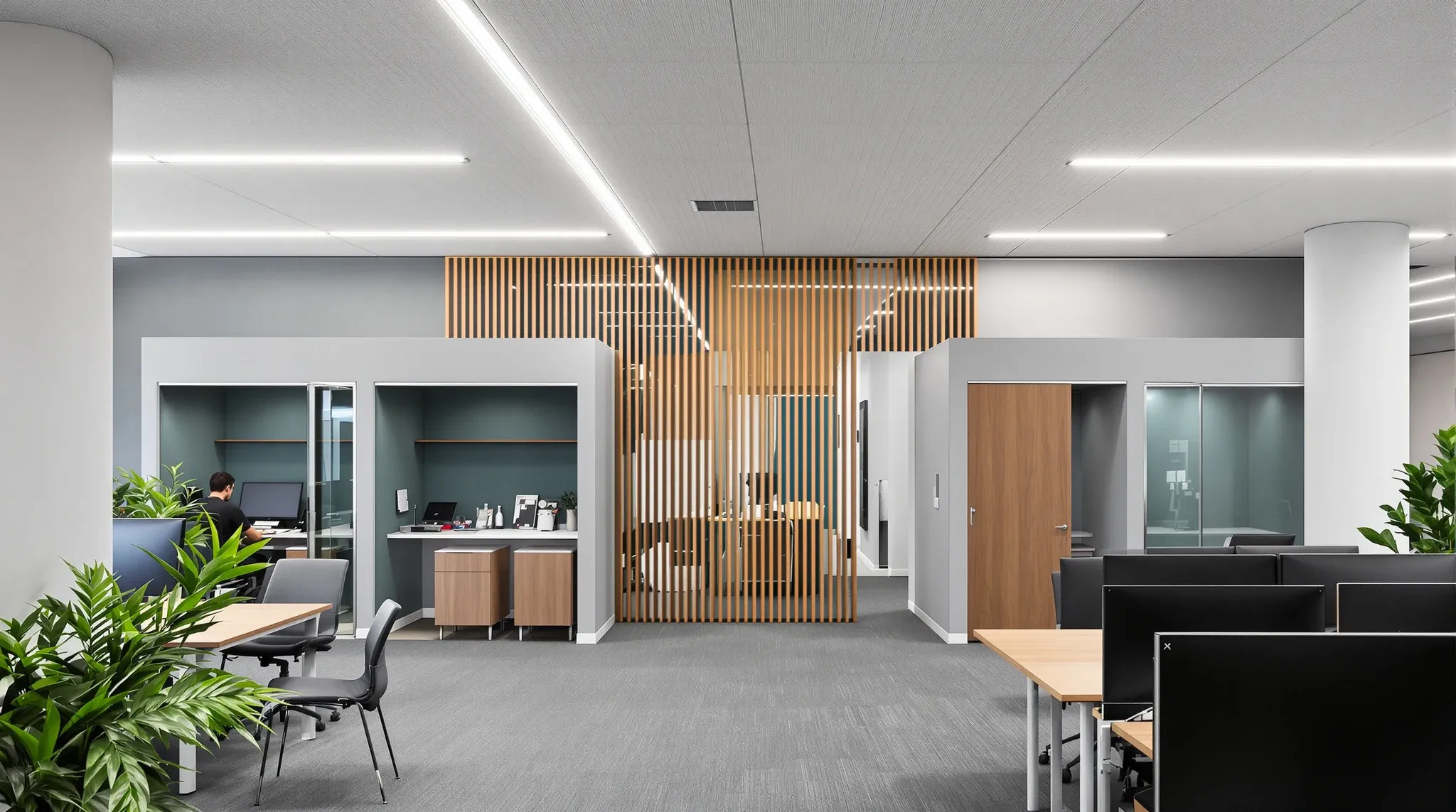 An office floor with sit-stand desks, two enclosed phone rooms and a timber-fronted quiet room
