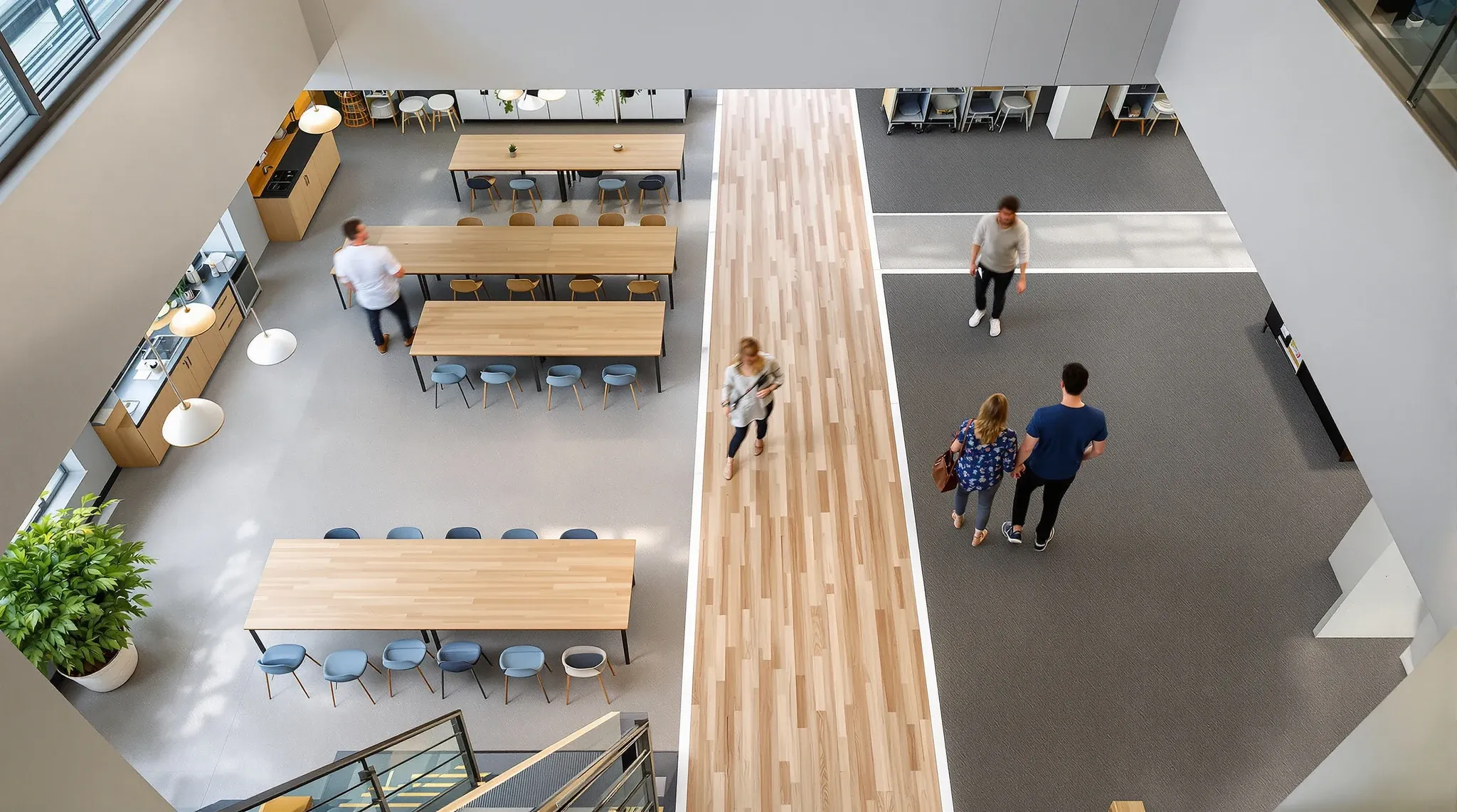 Polished concrete, timber-look flooring and carpet tiles meeting in different office zones