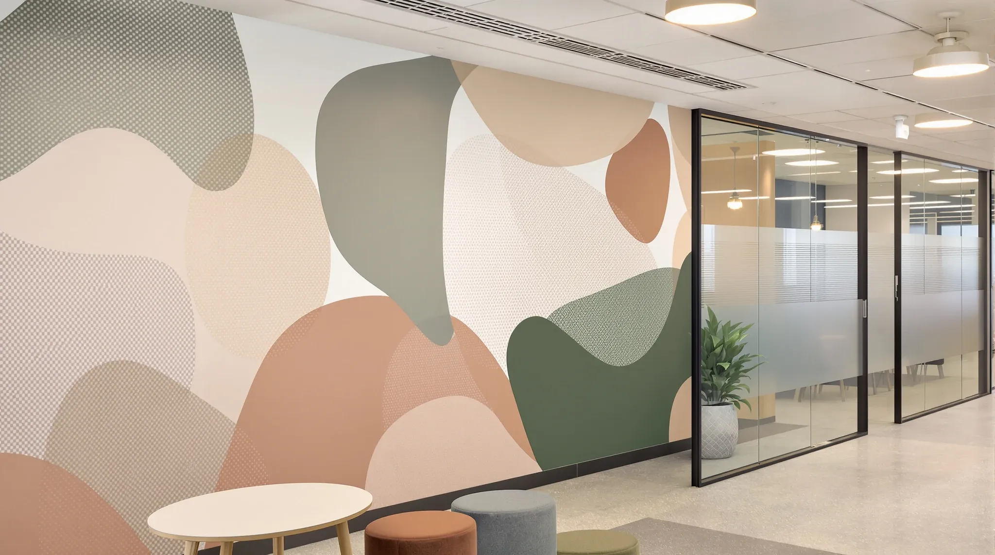 A breakout area with a large abstract wall graphic and patterned film on a glass wall