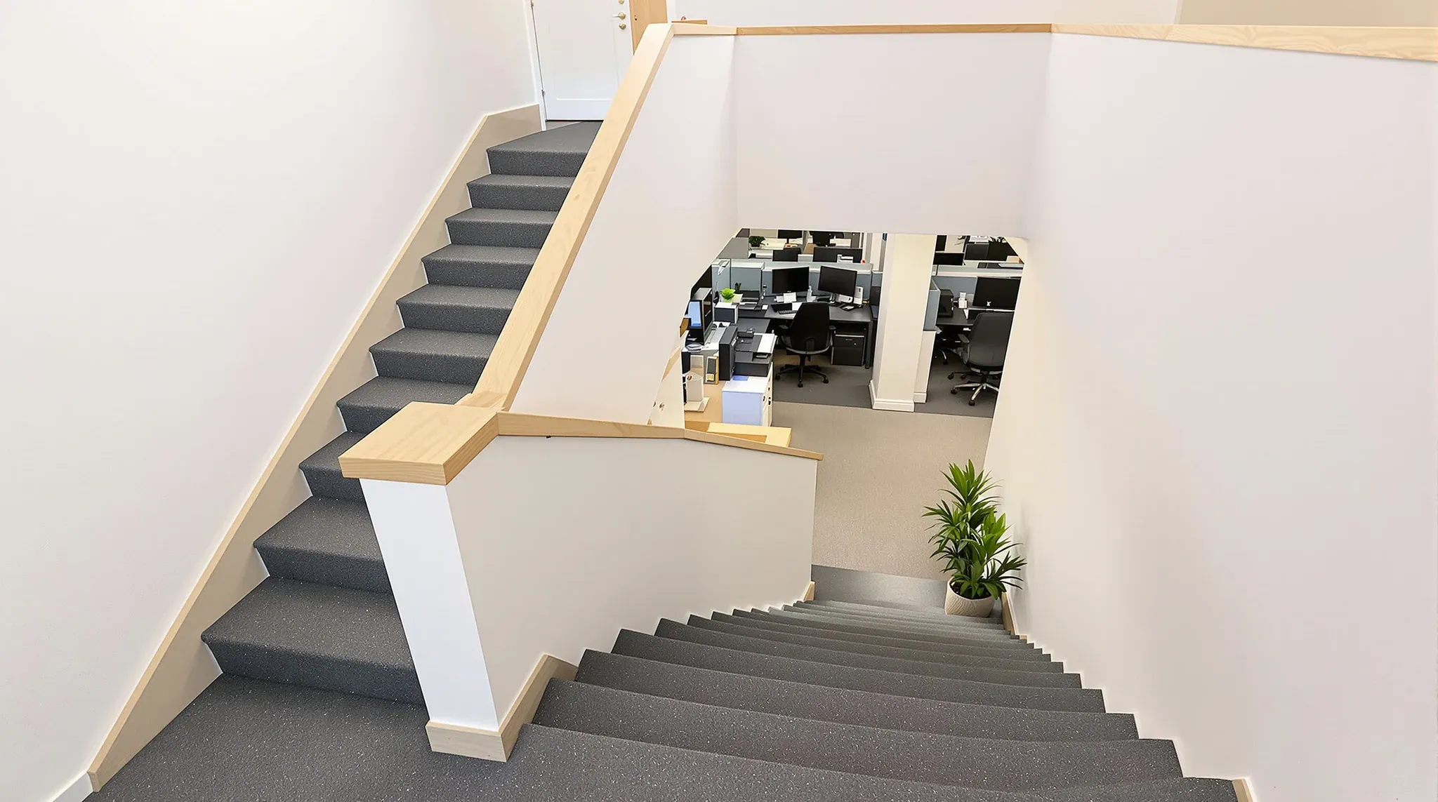 Looking down a straight internal stair to the lower floor of a two-level office tenancy