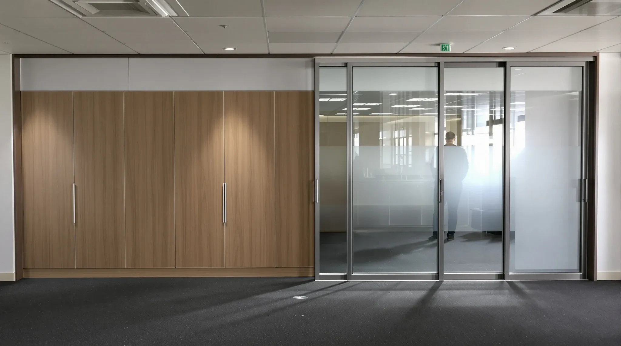 A person looking into an empty boardroom with built-in joinery left by a previous tenant