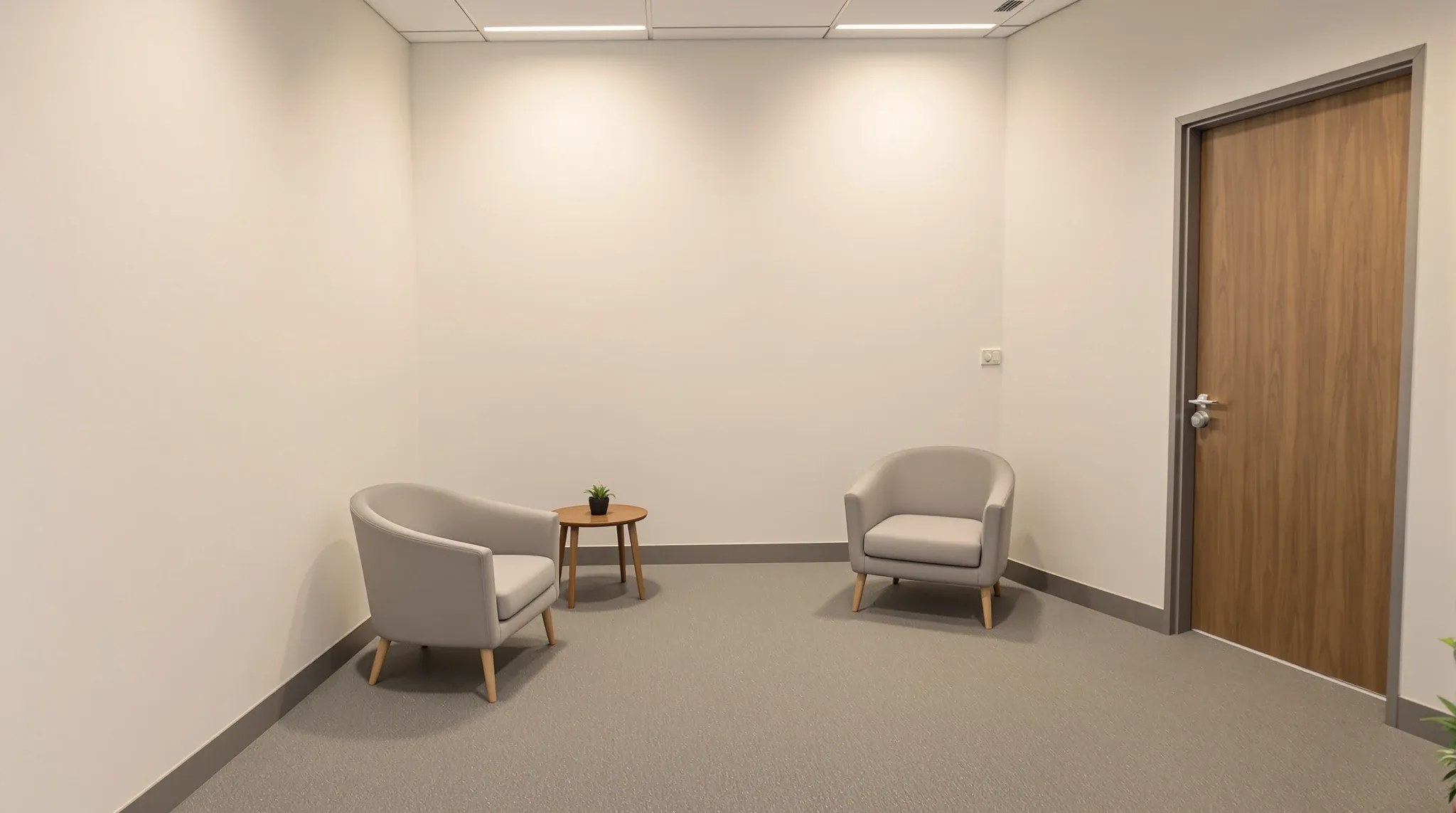 Calm empty consulting room with two armchairs, soft lighting, solid door