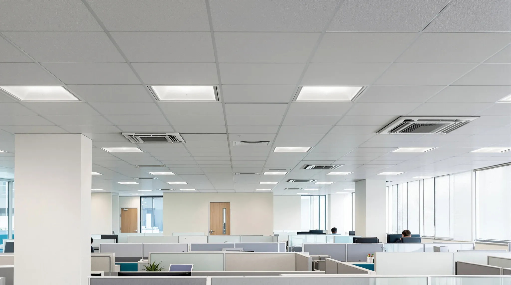 A refurbished office in an older tower, with a deep bulkhead along the core and new ceiling air conditioning units