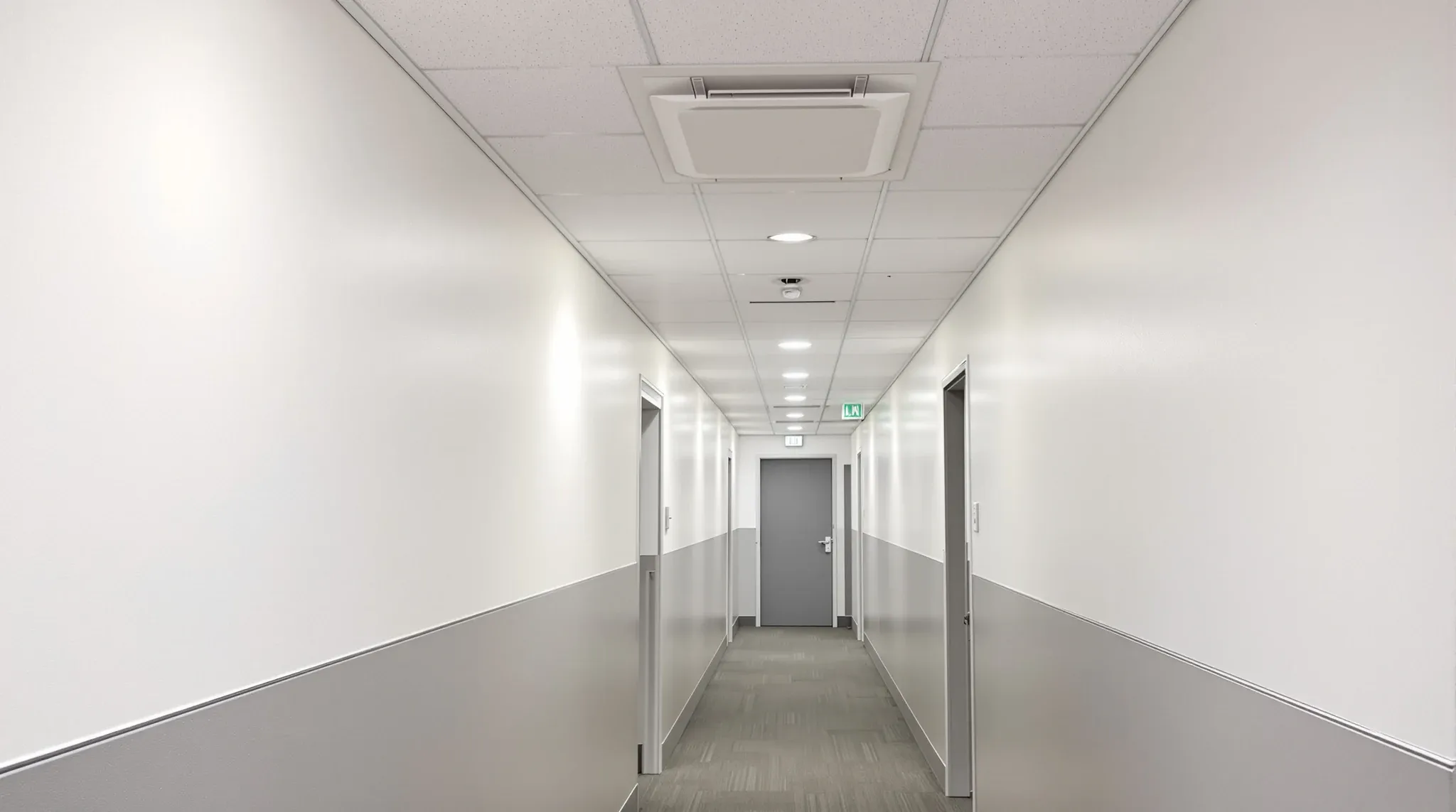 An office corridor bulkhead with a single flush ceiling access panel