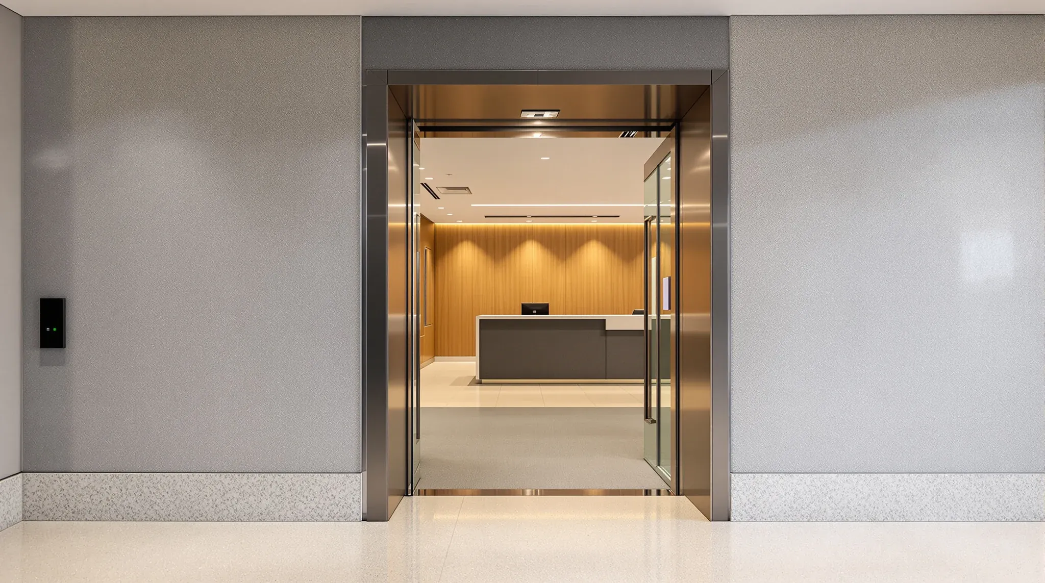 A lift lobby threshold where a base building finish meets a tenant office fitout