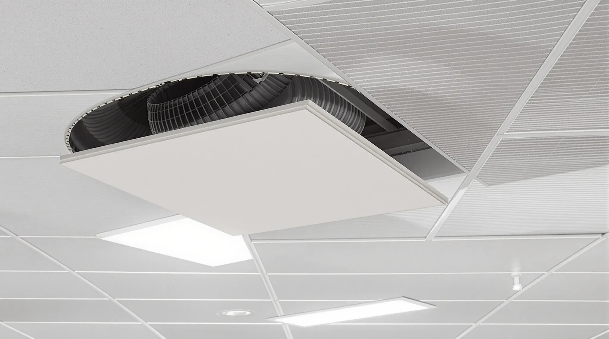 View up into an open office ceiling grid with one tile lifted showing ductwork, no text