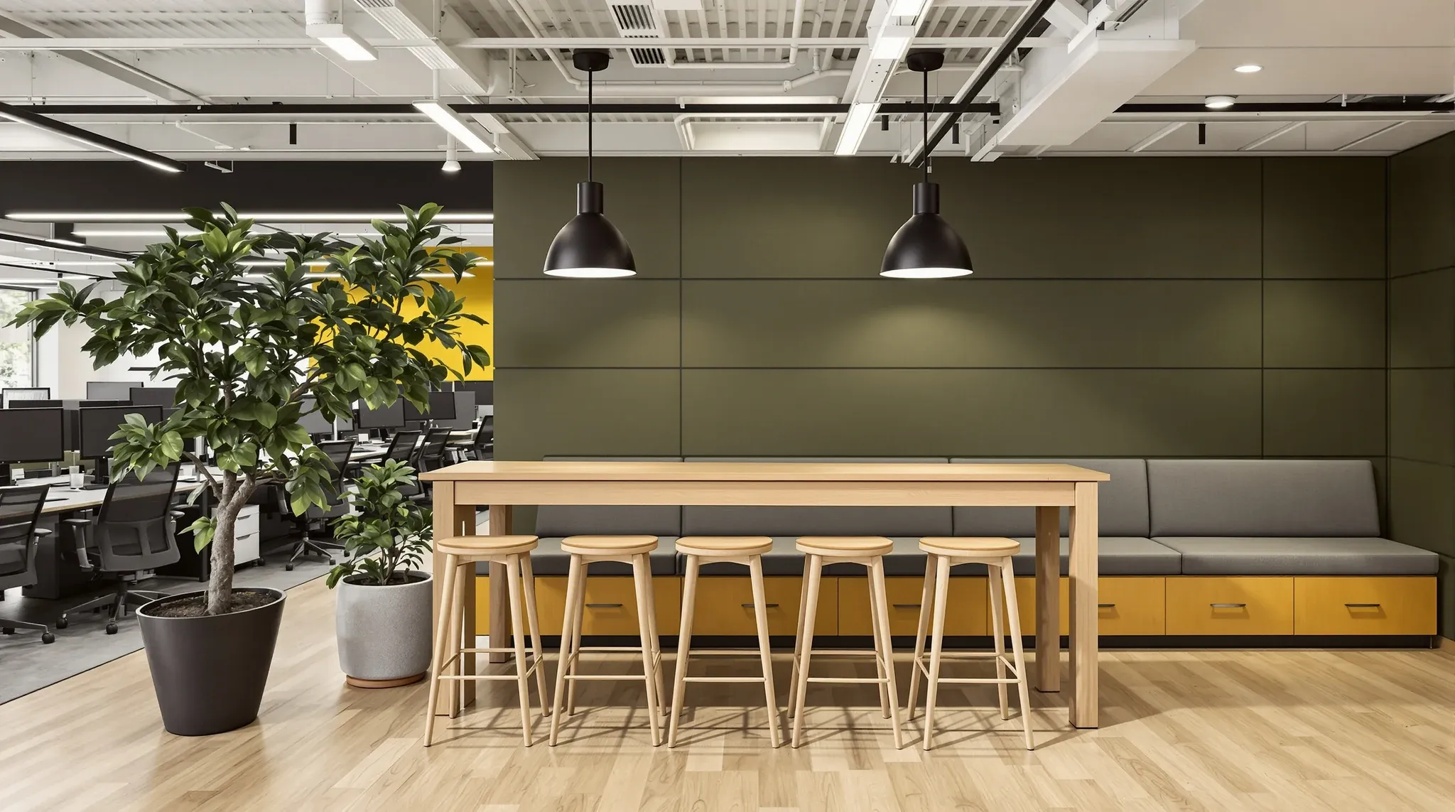A standing-height oak project table with tall stools in the middle of an open-plan office