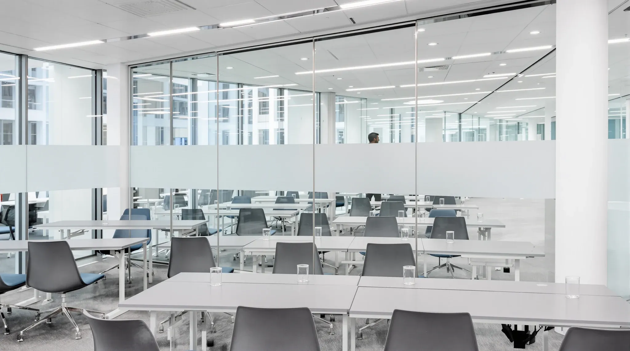 A training room with a glass front onto a corridor and a plain frosted band across the glass