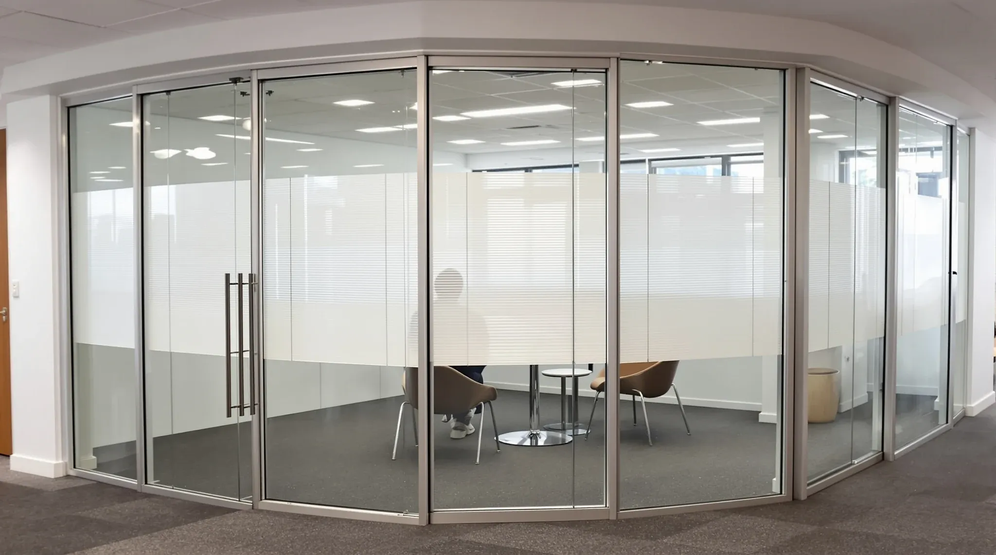 A double-glazed office partition with venetian blinds sealed between the two panes of glass