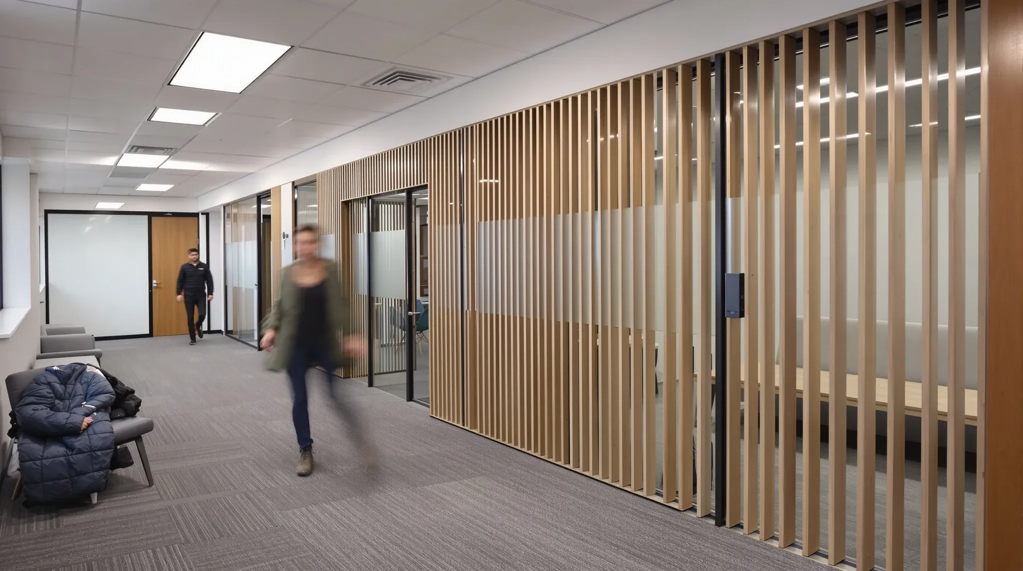 A plasterboard focus room, a glass meeting room and a screened breakout nook side by side in an office