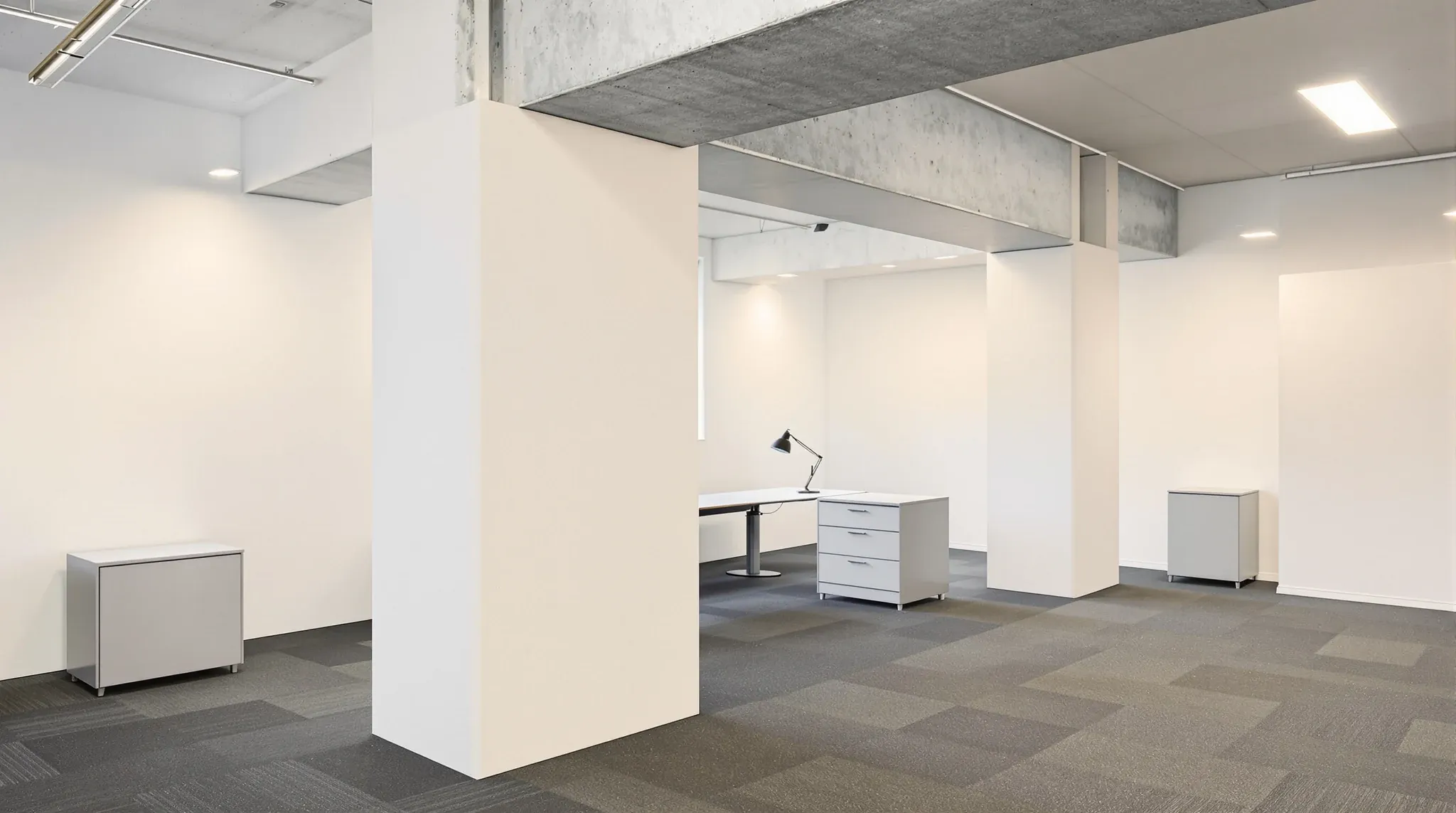 A new plasterboard wall meeting a chunky concrete column under a low beam in an older office building