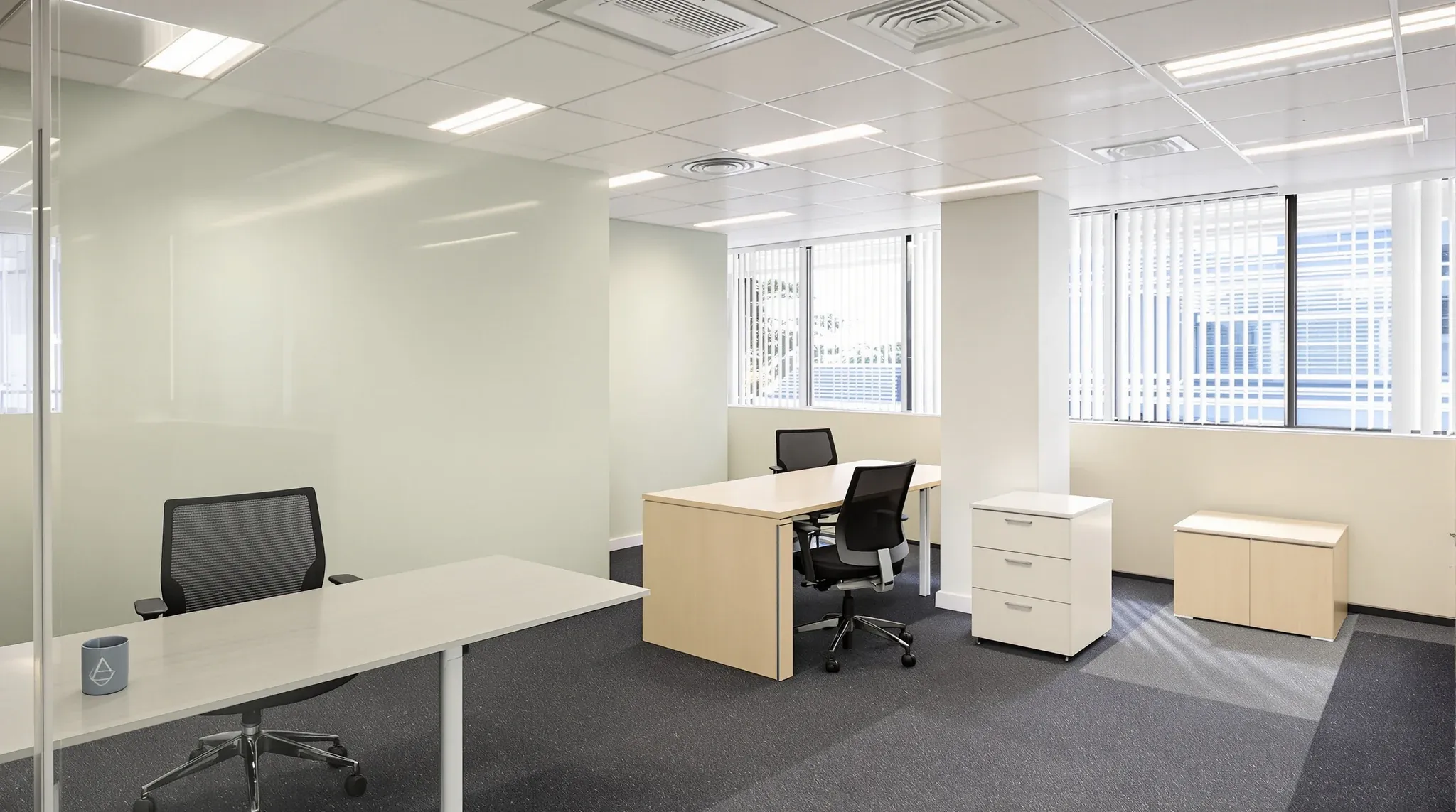 An existing office refreshed with new carpet and a painted feature wall, with the original desks kept