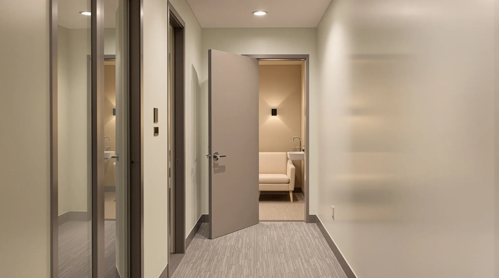 A quiet side corridor with a small wellness room, its door ajar