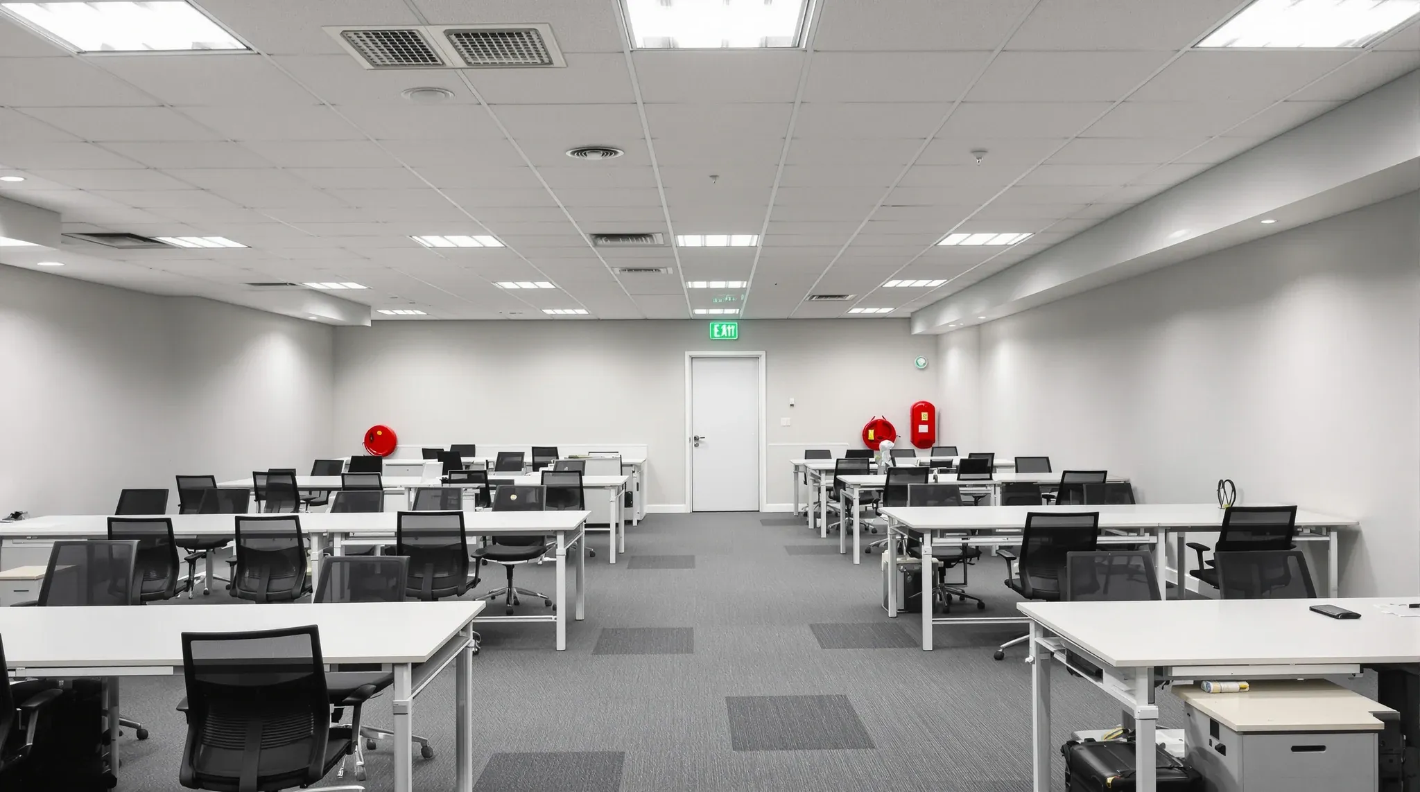 A finished office floor showing ordinary compliance features including an exit sign