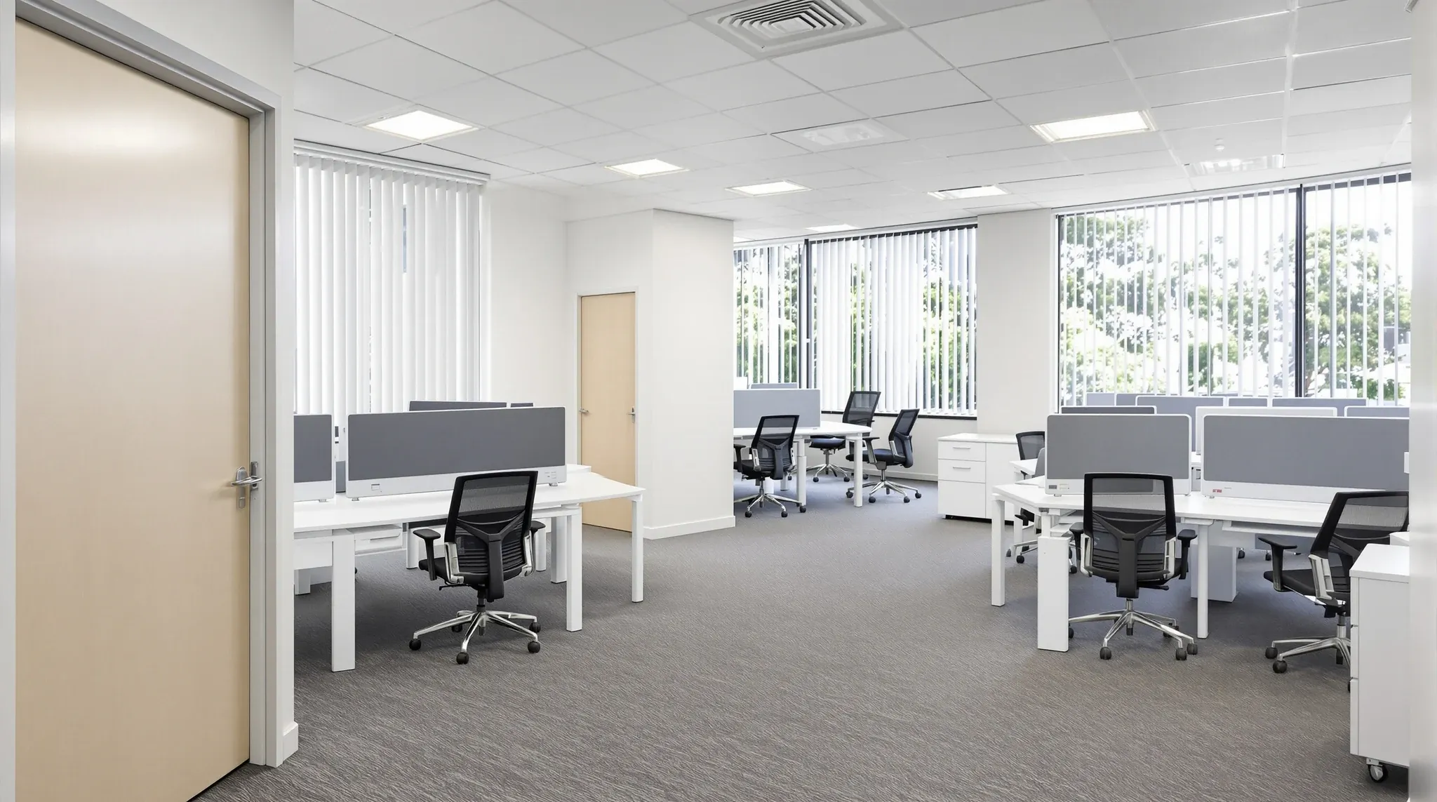 A small furnished office suite ready for a tenant to move in, seen from the entry door