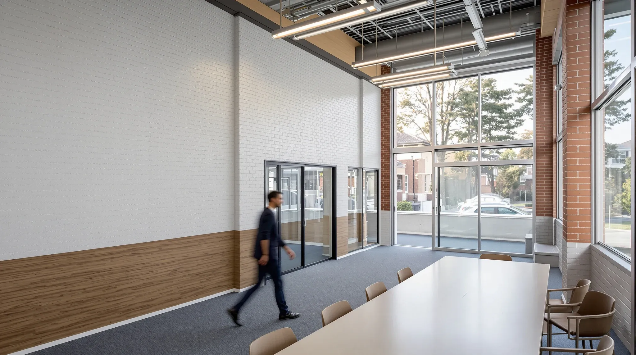 A regional office in an older brick building with a meeting table, small glass offices and wide windows