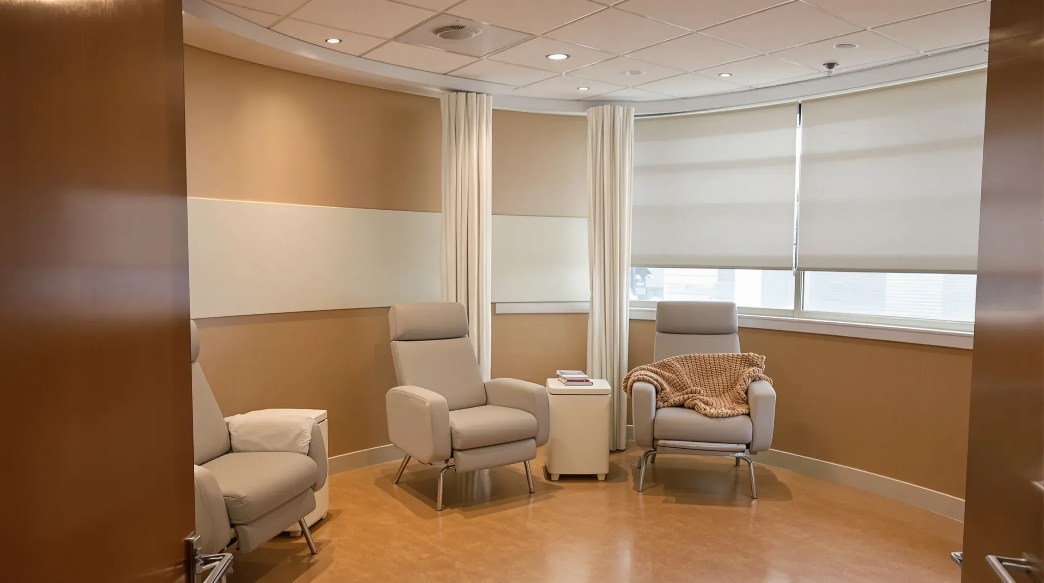 Oncology day unit treatment pod with recliner chairs, privacy curtains and blinds on the windows