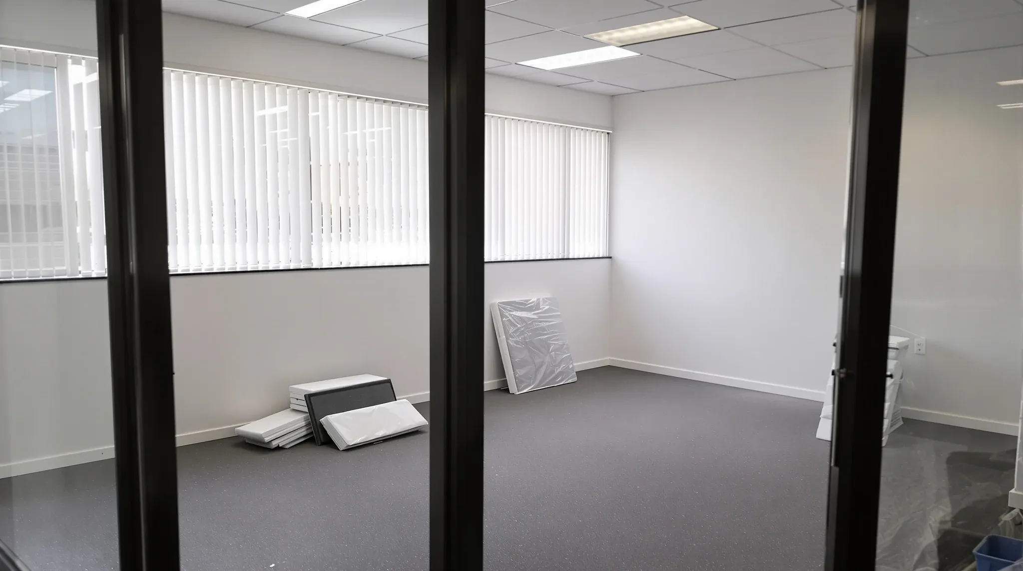 An empty small office mid make good, with floor protection over new carpet and fresh paint