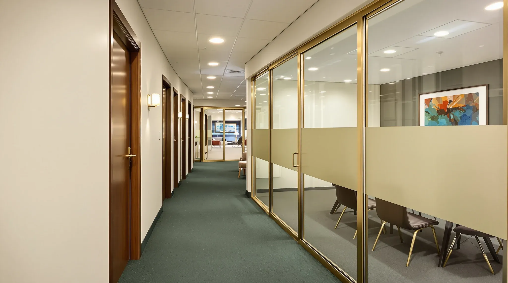 A law office corridor with solid timber-doored offices facing glass-fronted client meeting rooms